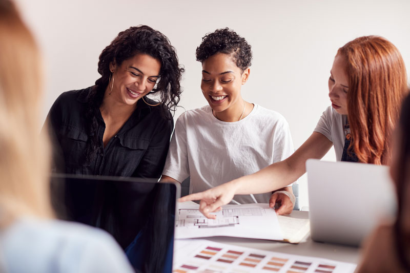 team-young-businesswomen-meeting-around-table